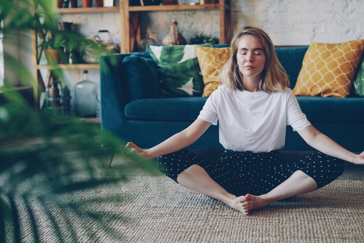 A person meditating calmly at home